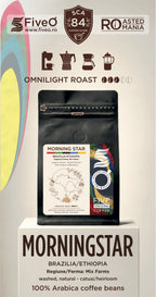 A package of FiveO Morning Star Omnilight Roast coffee beans displayed on a white pedestal. The product packaging is a black stand-up pouch with a white and multicolor label.