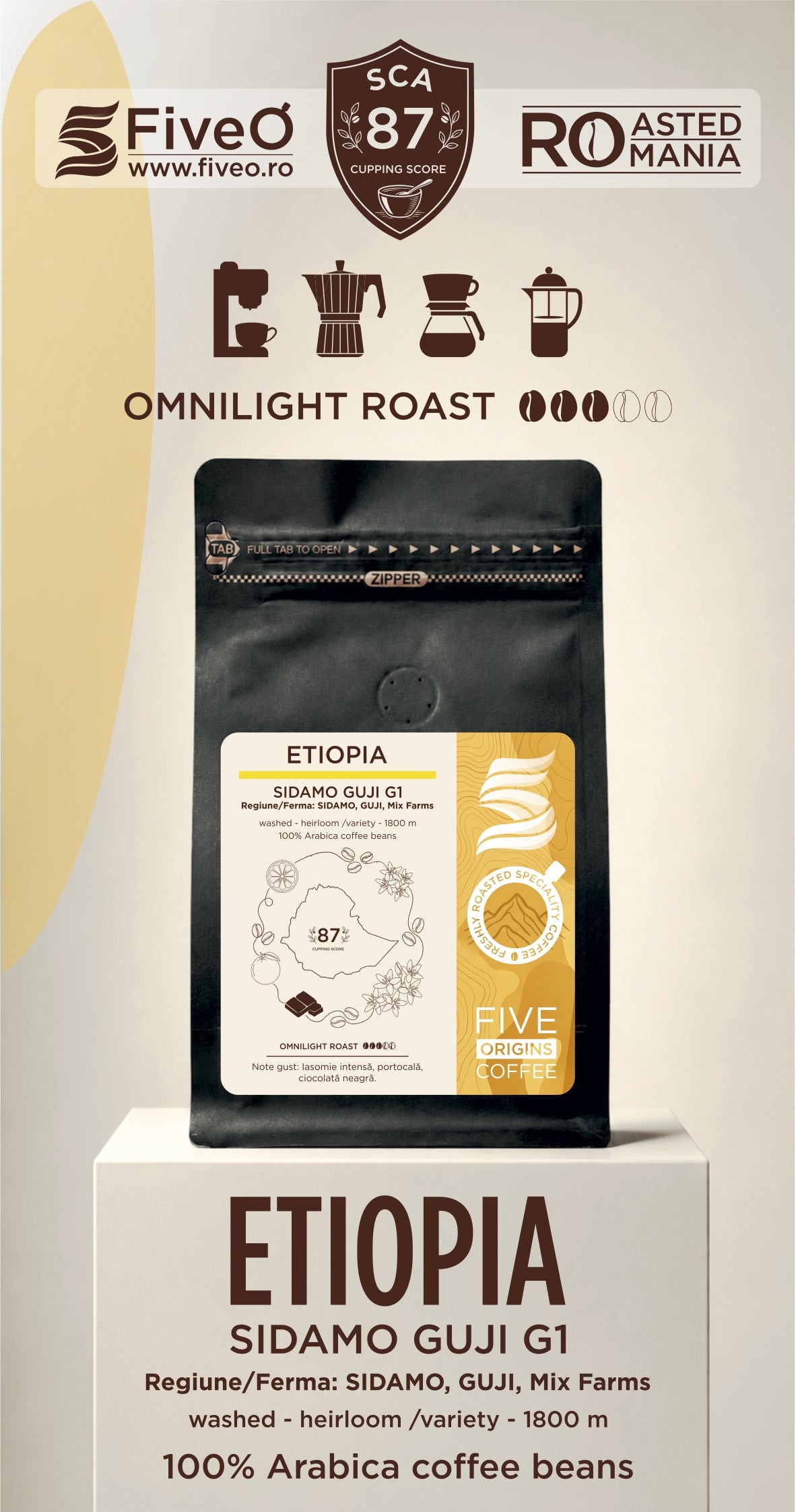 A coffee bag product display on a pedestal with branding and roast information. The main subject is a black coffee bag labeled 'ETIOPIA SIDAMO GUJI G1' with a cream and gold label.