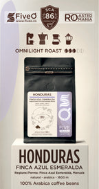 A package of FiveO Omnilight Roast Honduras coffee beans displayed on a white pedestal. The product packaging is a black stand-up pouch with a white and purple label. The best single origin speciality coffee frm honduras